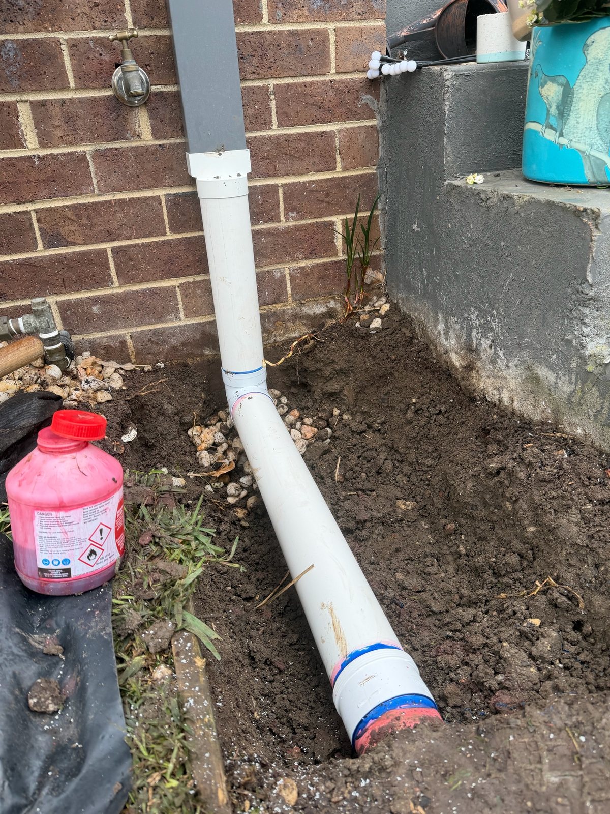 New PVC stormwater section installed beside a Brunswick West downpipe