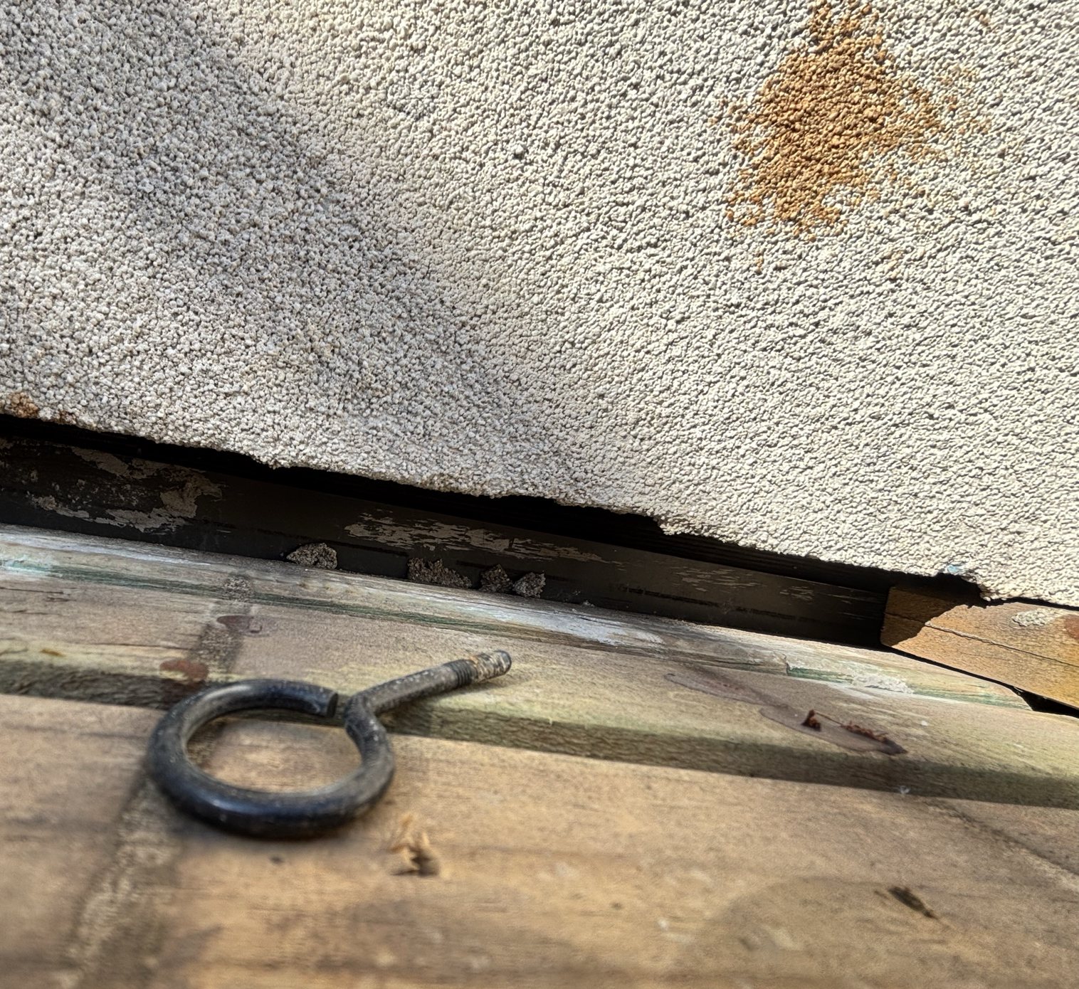 Deck-board opening used to investigate a concealed water leak in Coburg North