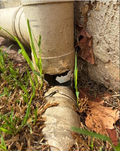 Damaged stormwater and downpipe connection before repair in Essendon