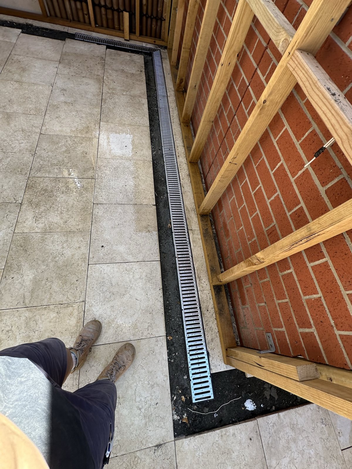 Graded strip drain installed along a courtyard wall in Essendon West