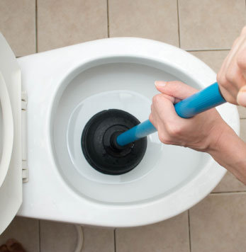 Plunging a blocked toilet