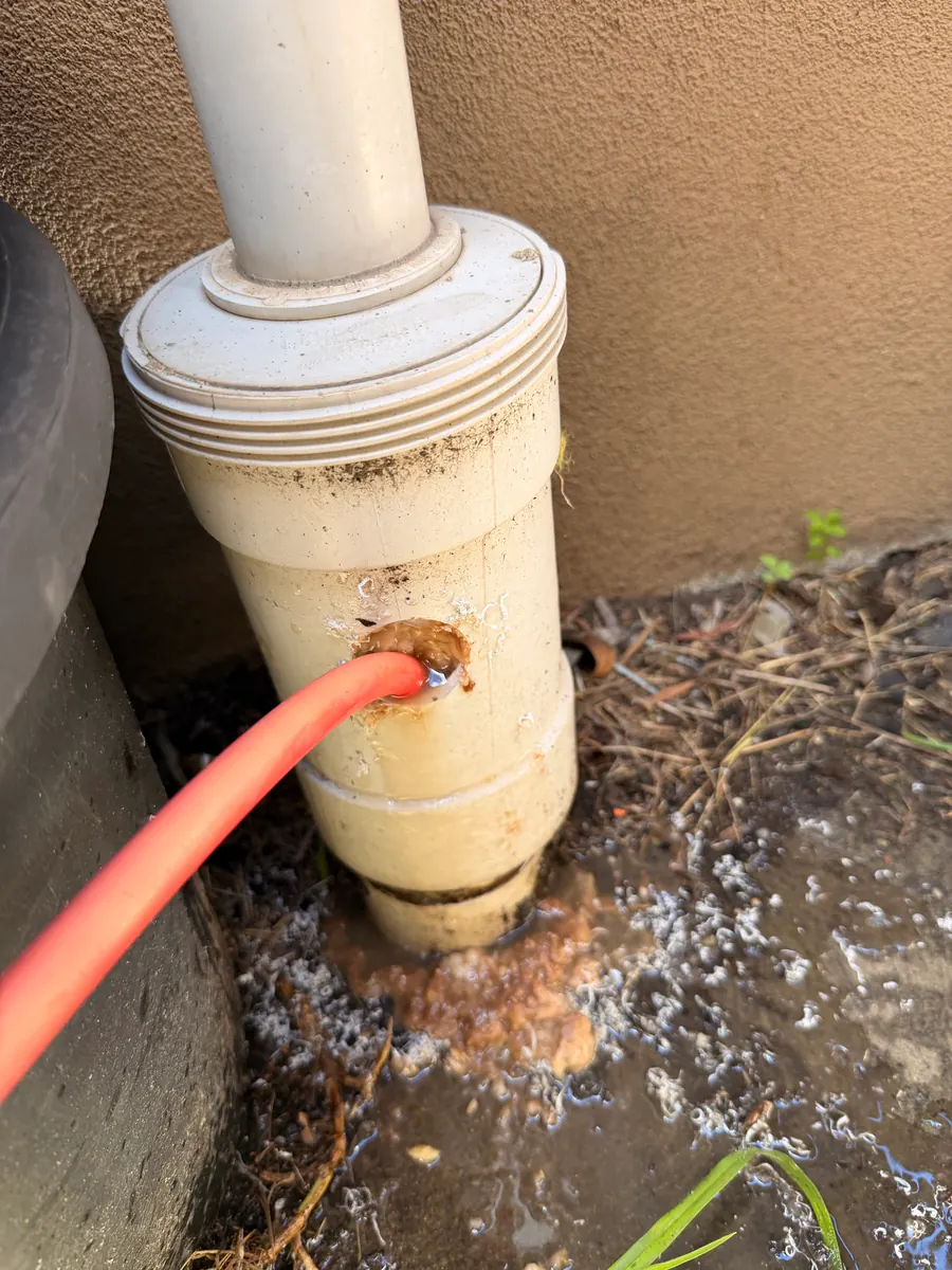 High-pressure sewer jetting through an outdoor sewer access point